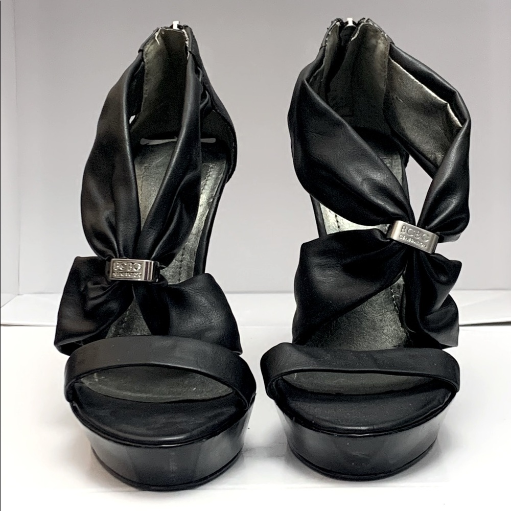 BCBGeneration black heels with logo accent and heel zippers, size 7